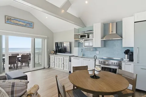 a view of a living room kitchen and a wooden floor