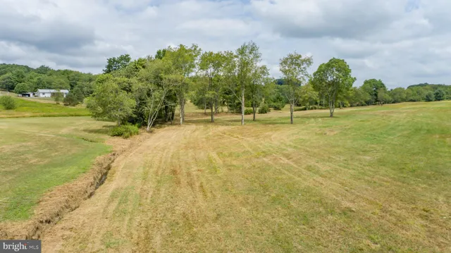 a swimming pool with an outdoor space and seating area