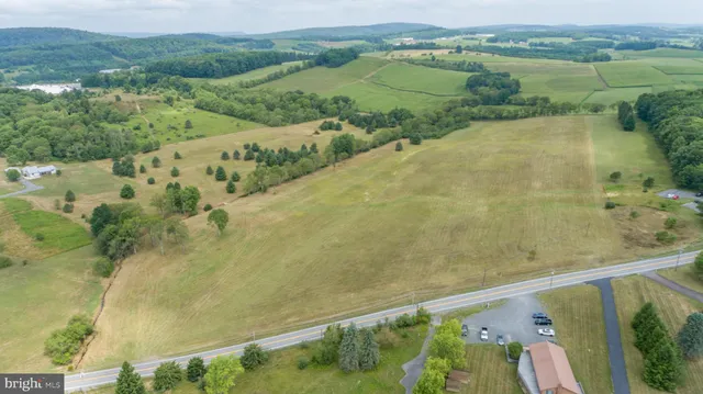 an aerial view of a residential houses with outdoor space and river