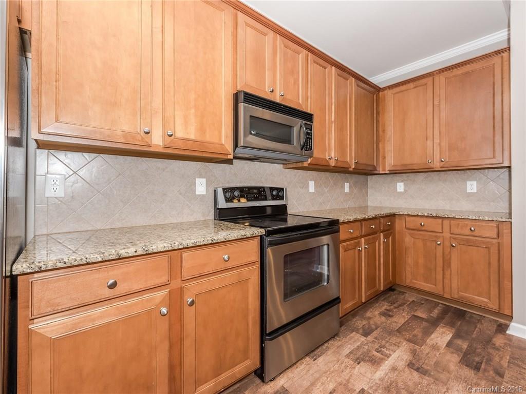2123 Midnight Blue Lane, Unit 191 Fort Mill, SC 29708 - Photo 14 of 34 a kitchen with stainless steel appliances granite countertop a sink stove and microwave
