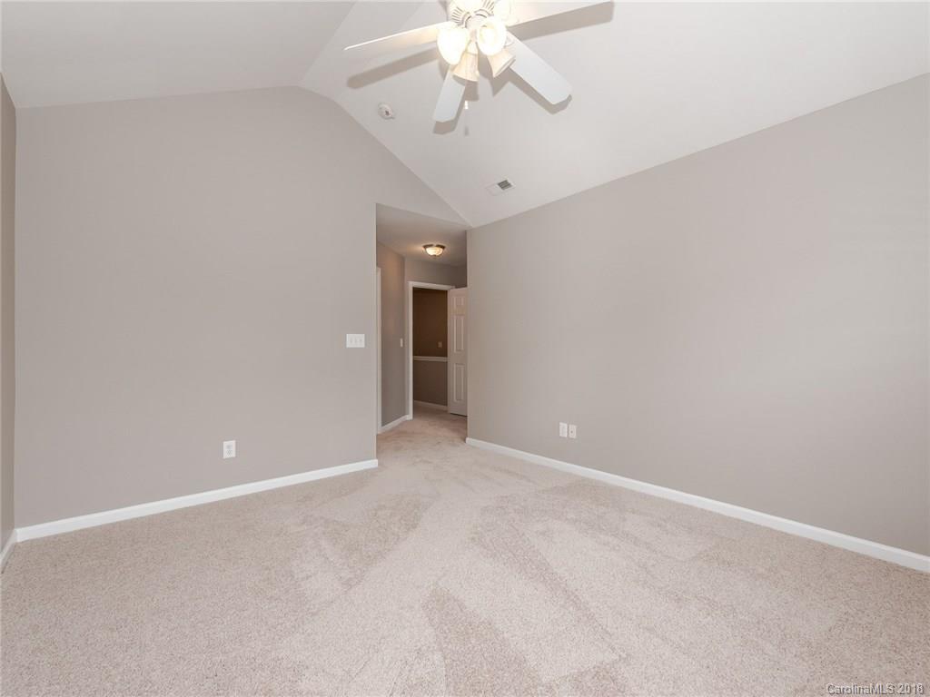2123 Midnight Blue Lane, Unit 191 Fort Mill, SC 29708 - Photo 22 of 34 an empty room with a chandelier fan and windows