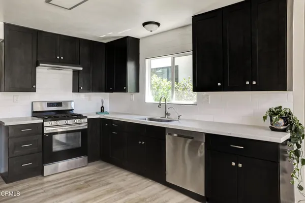 a kitchen with a sink and a stove