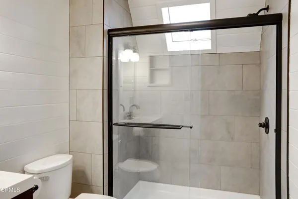 a bathroom with a shower and toilet