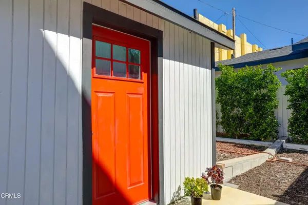 a view of a house with a door and wooden walls