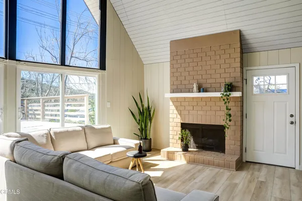a living room with furniture a fireplace and a window