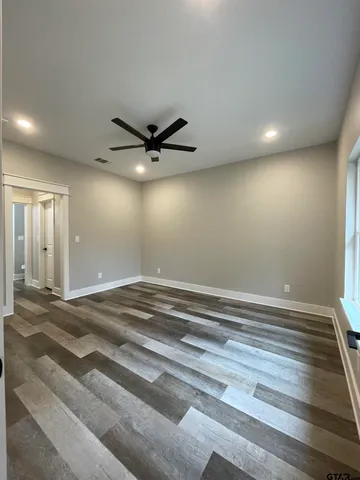 a view of a livingroom with a ceiling fan and wooden floor