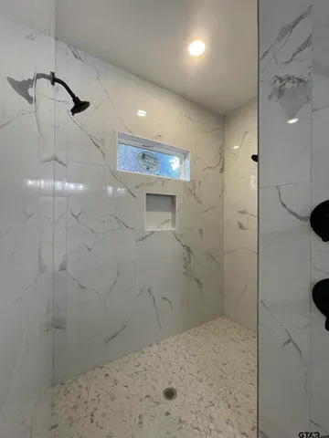 a view of a livingroom with a ceiling fan and wooden floor