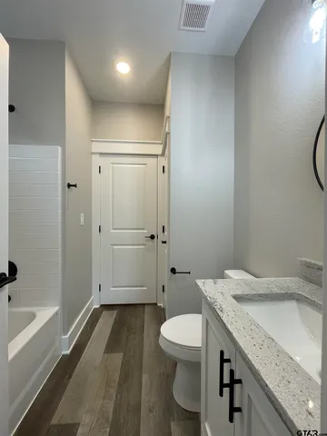 a bathroom with a sink and toilet