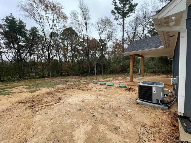 a backyard of a house with barbeque oven