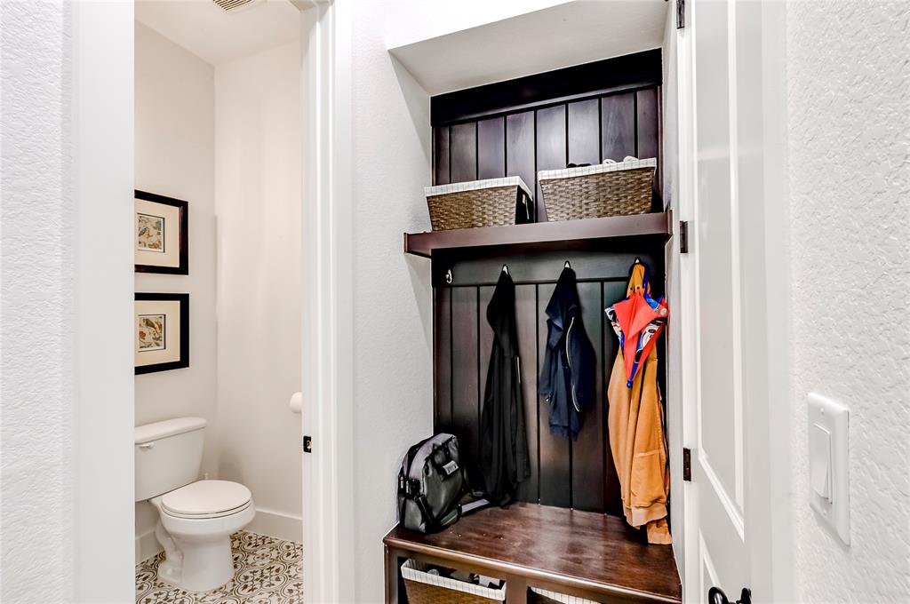 126 LITTLE Strm Cove Austin, TX 78737 - Photo 20 of 40 A well-appointed mudroom features built-in storage with a bench and hooks, conveniently located near a powder room.