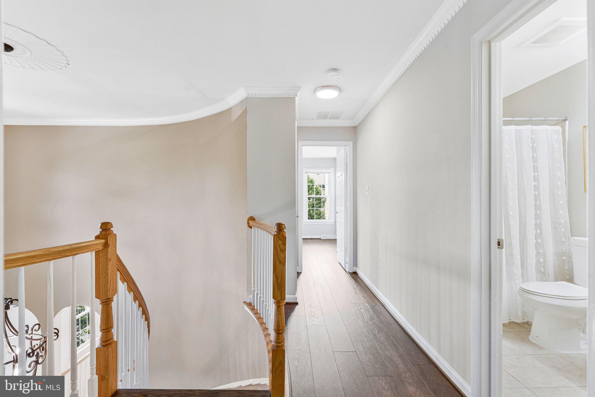 2000 Gallows Tree Lane Vienna, VA 22182 - Photo 22 of 58 a view of a hallway with wooden floor and staircase