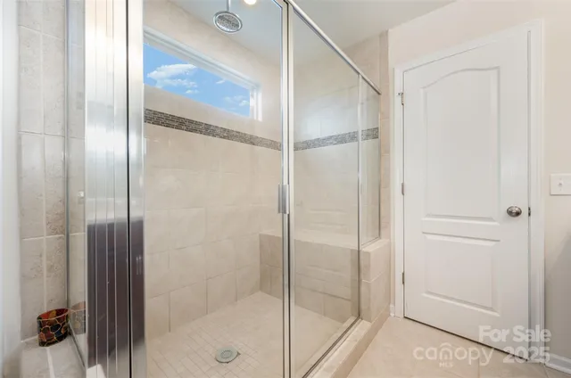a bathroom with a glass shower door