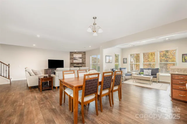 a living room with furniture flat screen tv and wooden floor