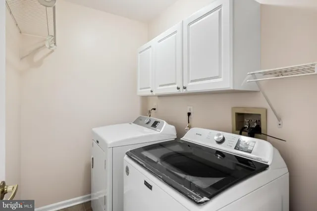 a view of washer and dryer with kitchen in the background