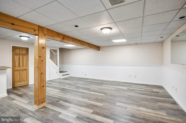a view of a room with wooden floor