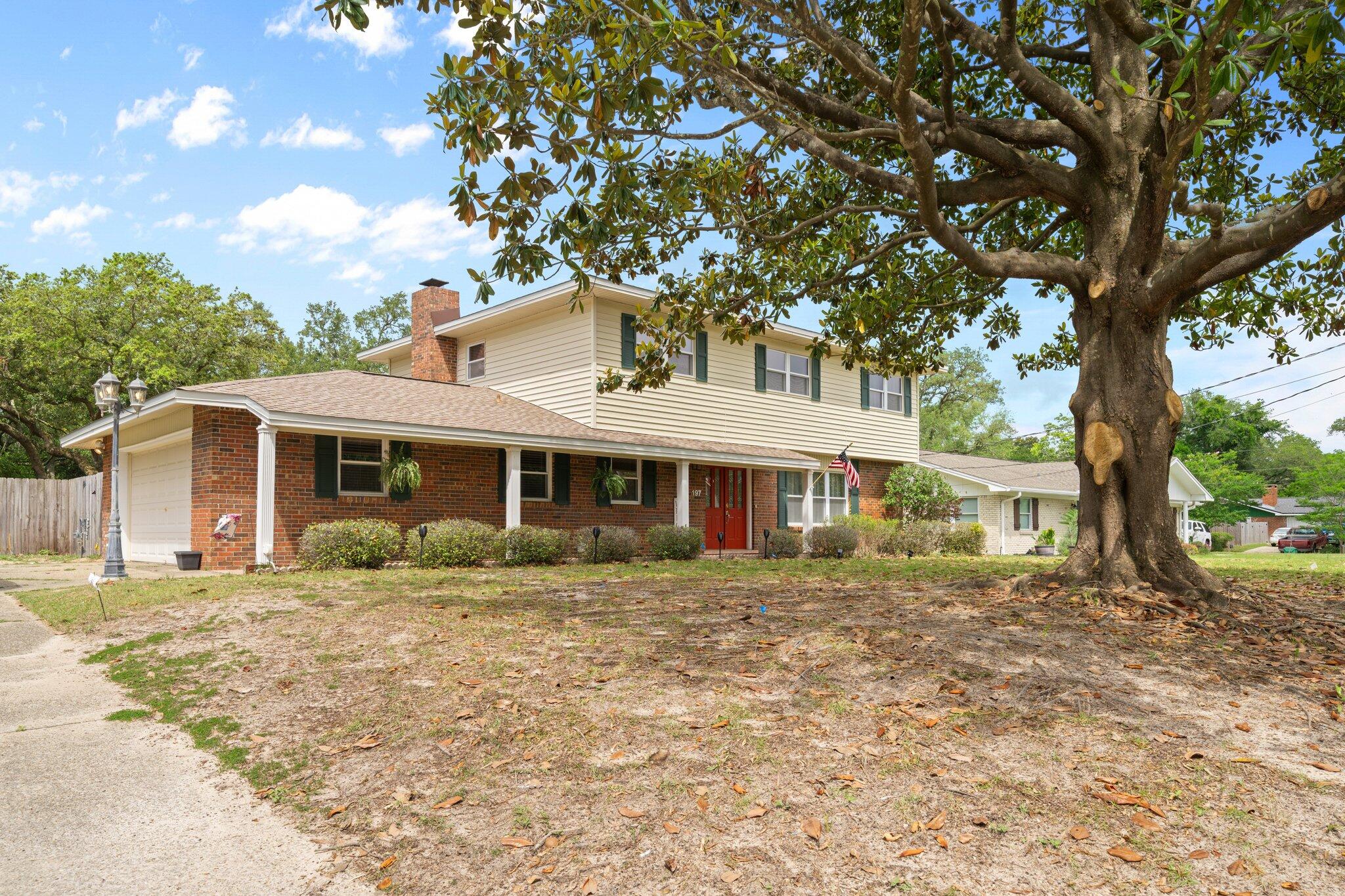 197 Country Club Road Shalimar, FL 32579 - Photo 1 of 1 a front view of a house with a garden