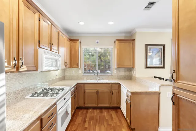 a kitchen with a sink stove and refrigerator