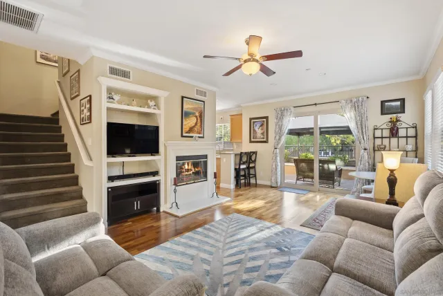 a living room with furniture a fireplace and a flat screen tv
