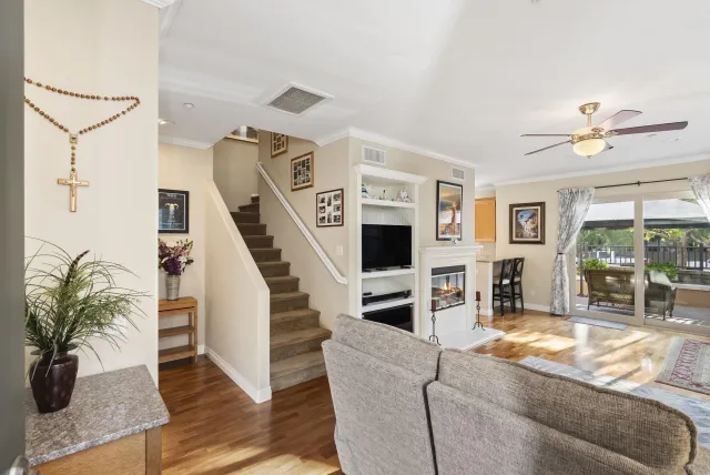 a living room with furniture and wooden floor