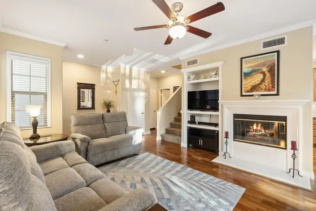 a living room with furniture a flat screen tv and a fireplace
