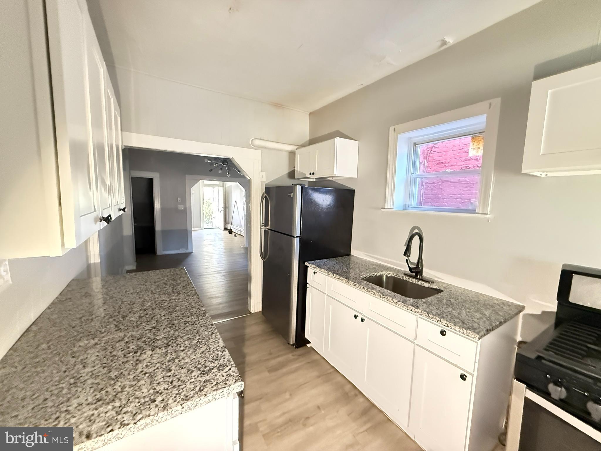 2662 Lehman Street Baltimore, MD 21223 - Photo 5 of 10 a kitchen with stainless steel appliances granite countertop a sink stove and refrigerator