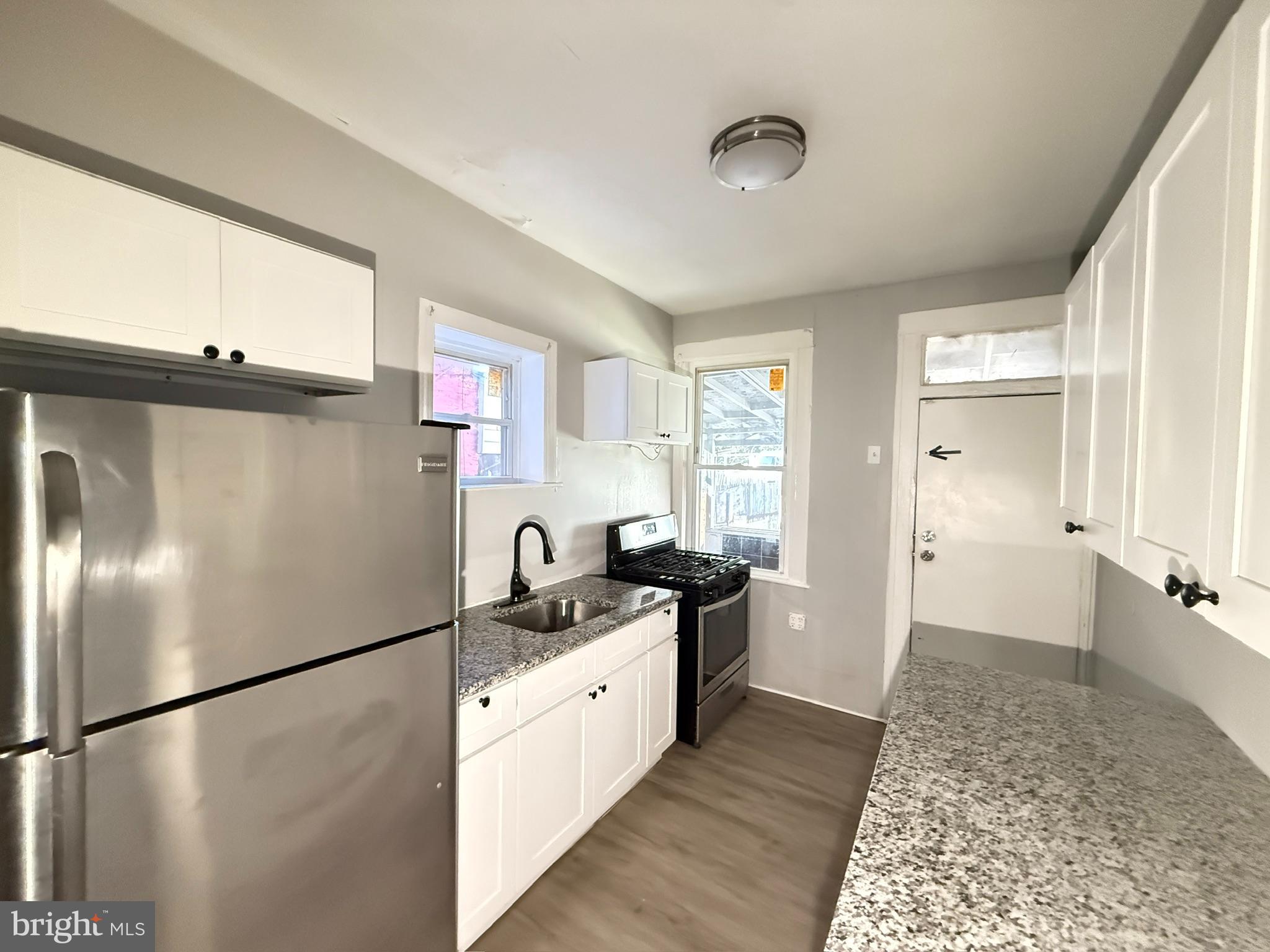 2662 Lehman Street Baltimore, MD 21223 - Photo 6 of 10 a kitchen with granite countertop a refrigerator and a sink