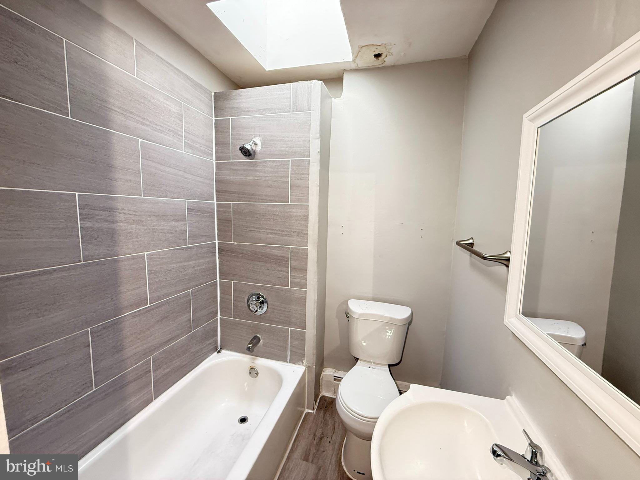 2662 Lehman Street Baltimore, MD 21223 - Photo 8 of 10 a white toilet sitting next to a bath tub