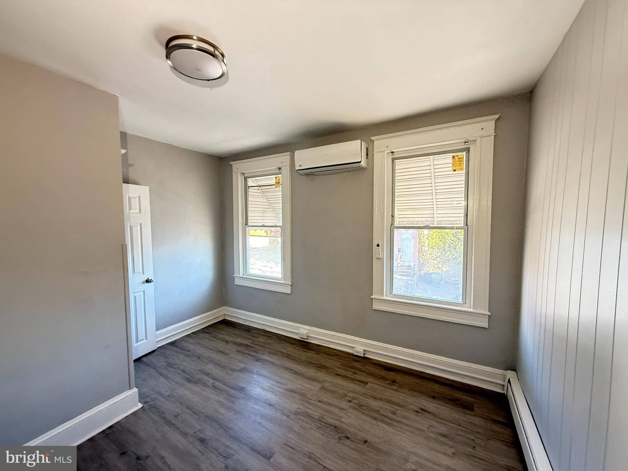 2662 Lehman Street Baltimore, MD 21223 - Photo 10 of 10 an empty room with wooden floor and windows