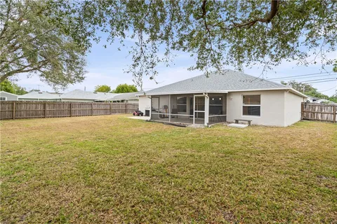 front view of a house with a large tree