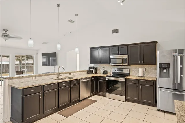 a kitchen with a sink a microwave and refrigerator
