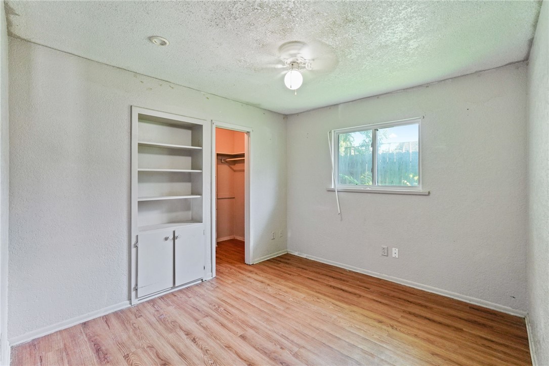 1806 Melisa Lane Corpus Christi, TX 78412 - Photo 12 of 13 an empty room with wooden floor closet and windows