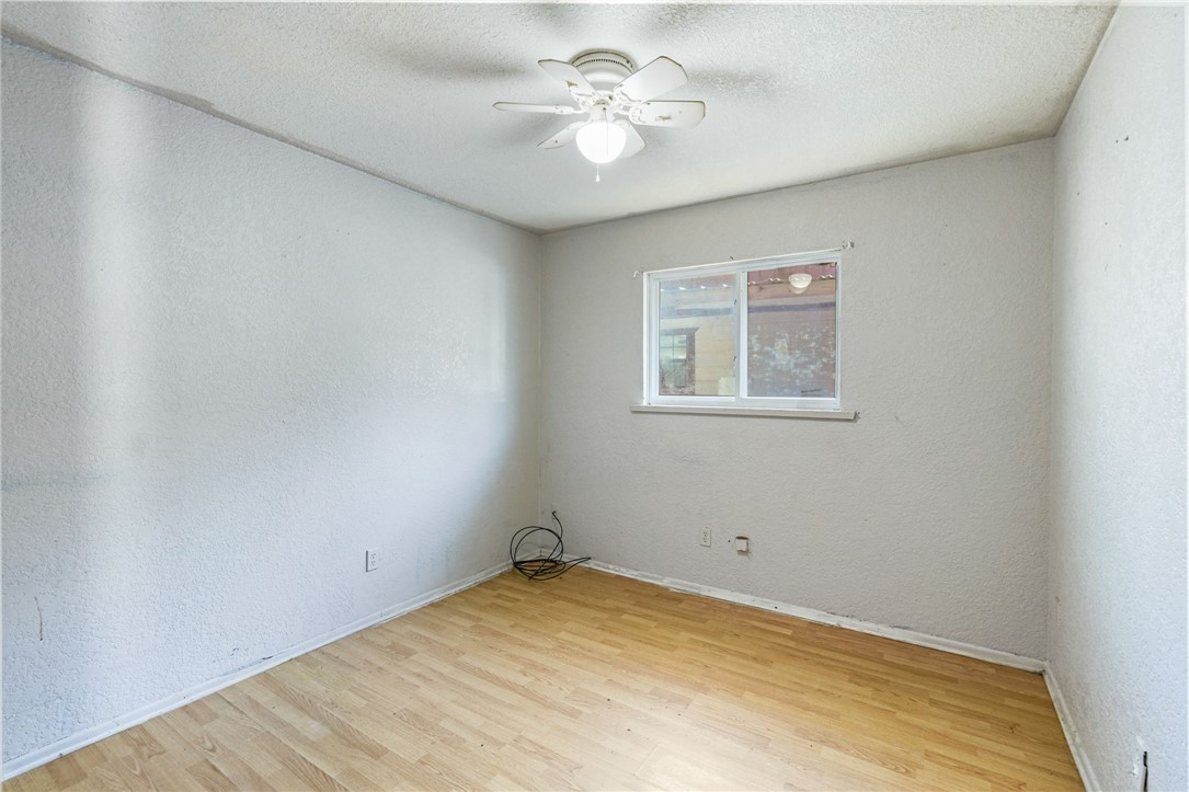 1806 Melisa Lane Corpus Christi, TX 78412 - Photo 4 of 13 an empty room with a window and a fan