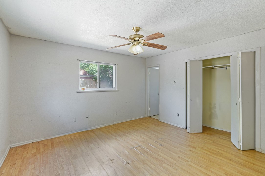 1806 Melisa Lane Corpus Christi, TX 78412 - Photo 5 of 13 a view of a big room with wooden floor and a ceiling fan