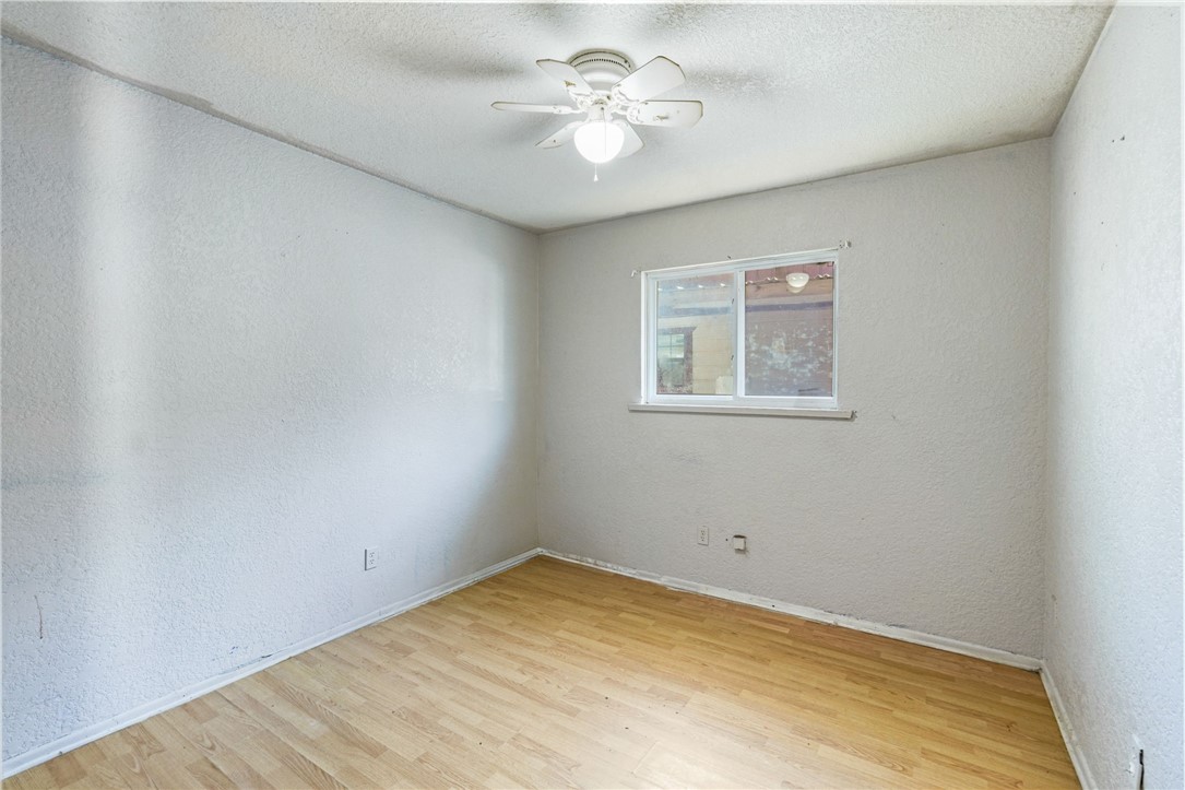 1806 Melisa Lane Corpus Christi, TX 78412 - Photo 6 of 13 an empty room with a window and a fan