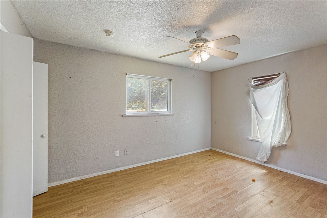 1806 Melisa Lane Corpus Christi, TX 78412 - Photo 10 of 13 wooden floor in an empty room with a window