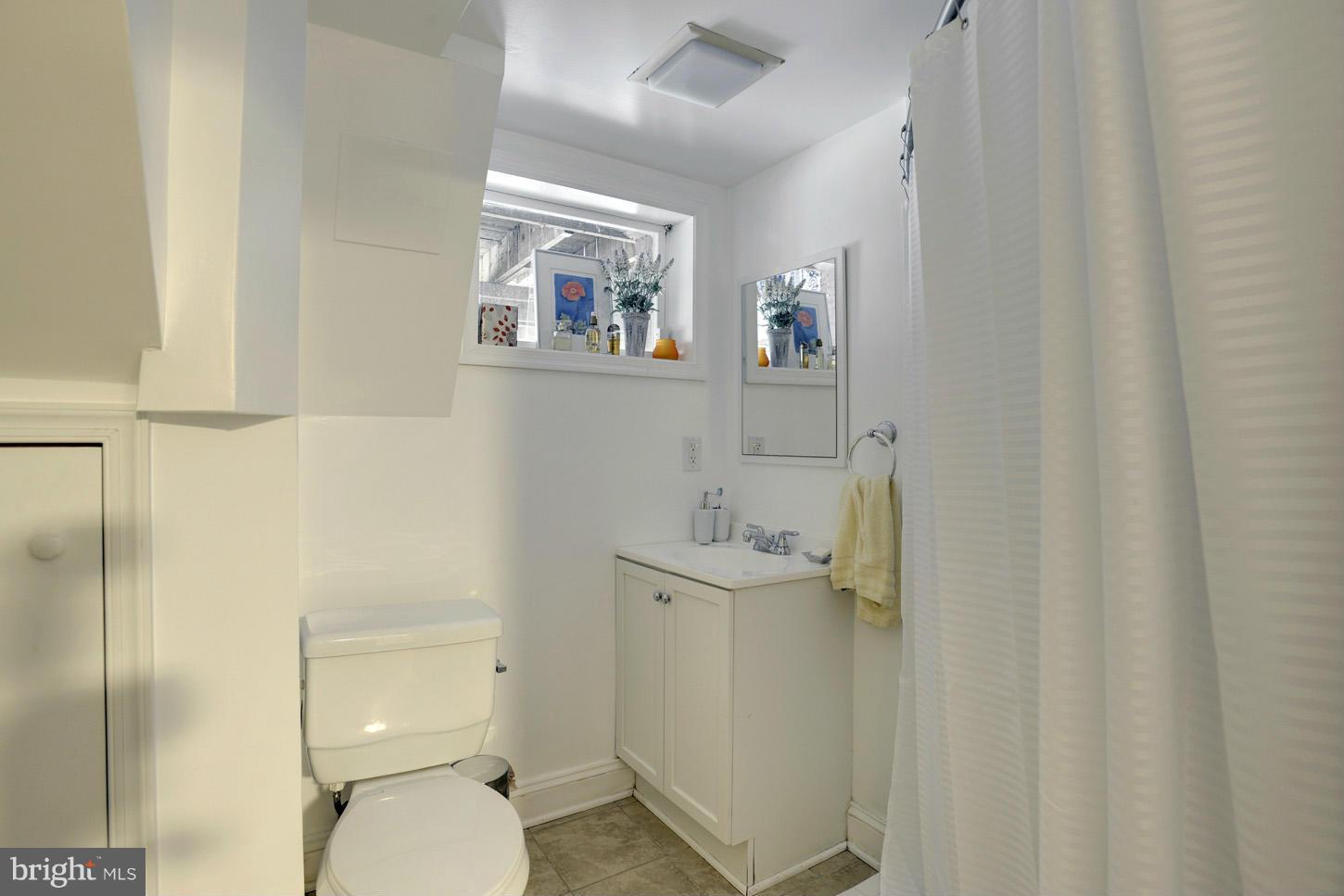 4625 Sedgwick Street Northwest Washington, DC 20016 - Photo 16 of 19 a bathroom with a toilet a sink and mirror