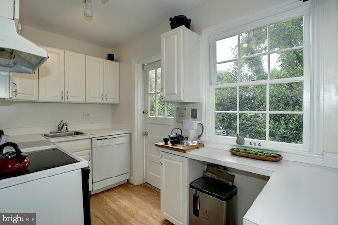 4625 Sedgwick Street Northwest Washington, DC 20016 - Photo 8 of 19 a kitchen with a sink a stove and cabinets