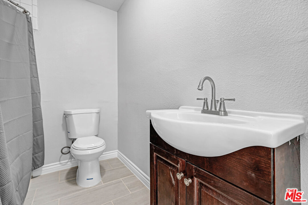 11170 Larkin Road Lucerne Valley, CA 92356 - Photo 14 of 14 a bathroom with a sink and a toilet