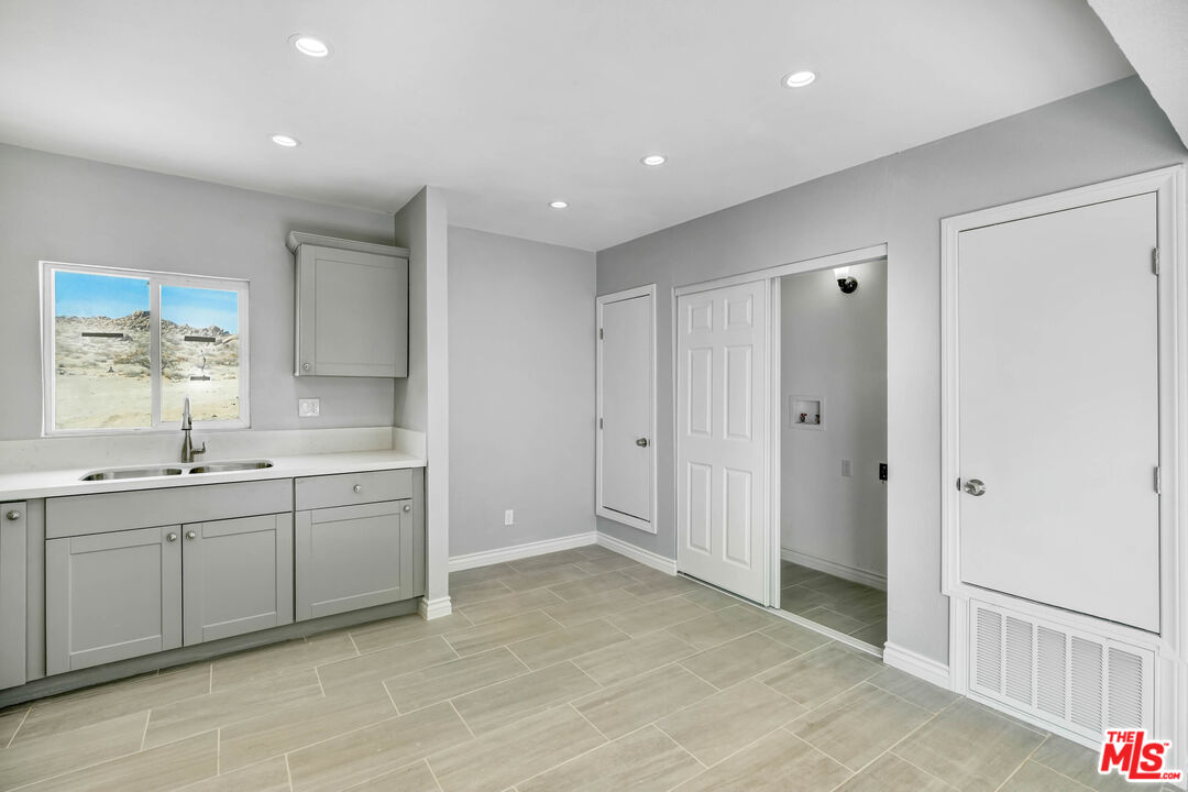 11170 Larkin Road Lucerne Valley, CA 92356 - Photo 9 of 14 a large bathroom with a sink and a mirror