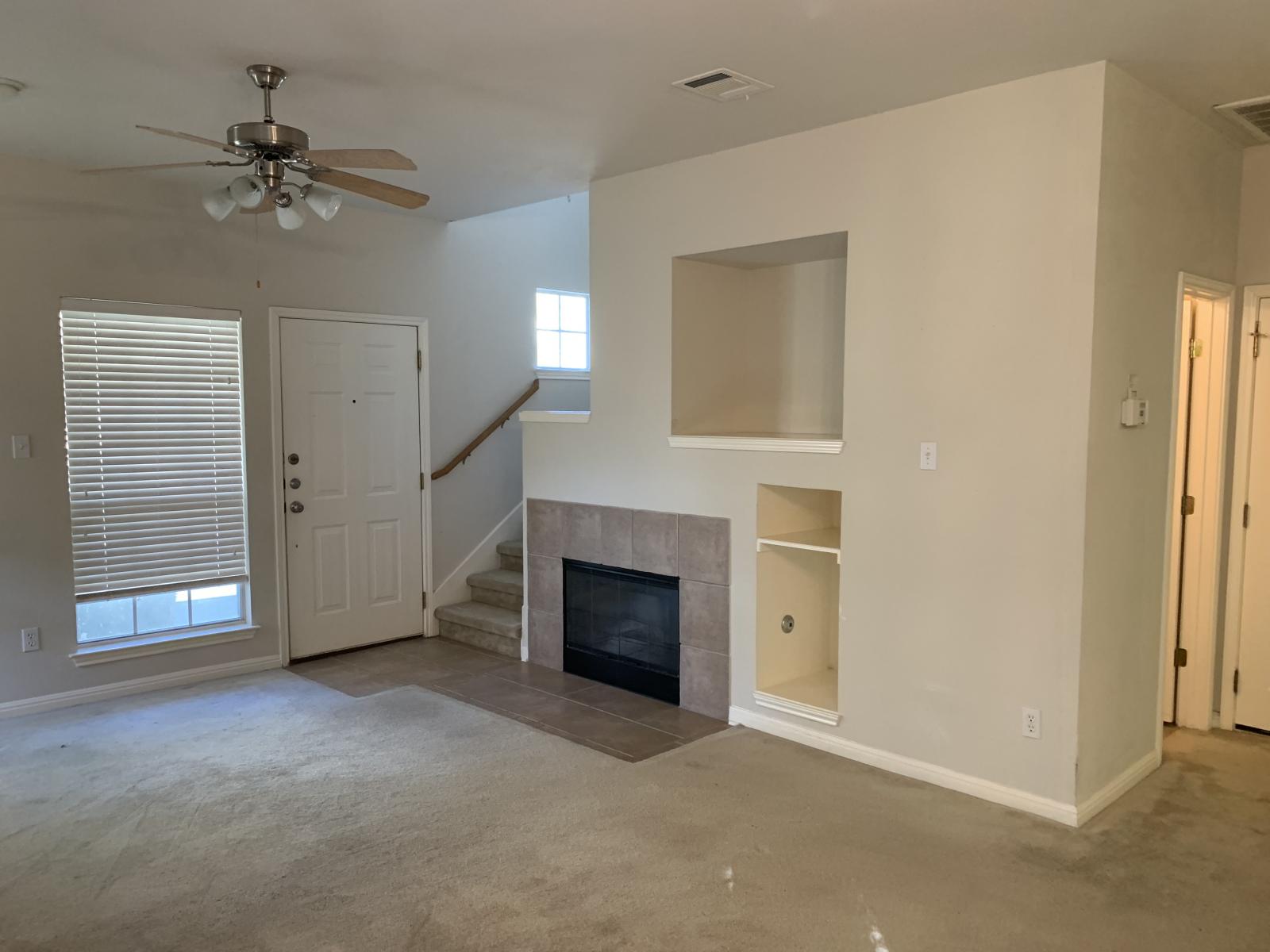 11000 Anderson Mill Road, Unit 29 Austin, TX 78750 - Photo 8 of 27 a view of a livingroom with a fireplace and ceiling fan