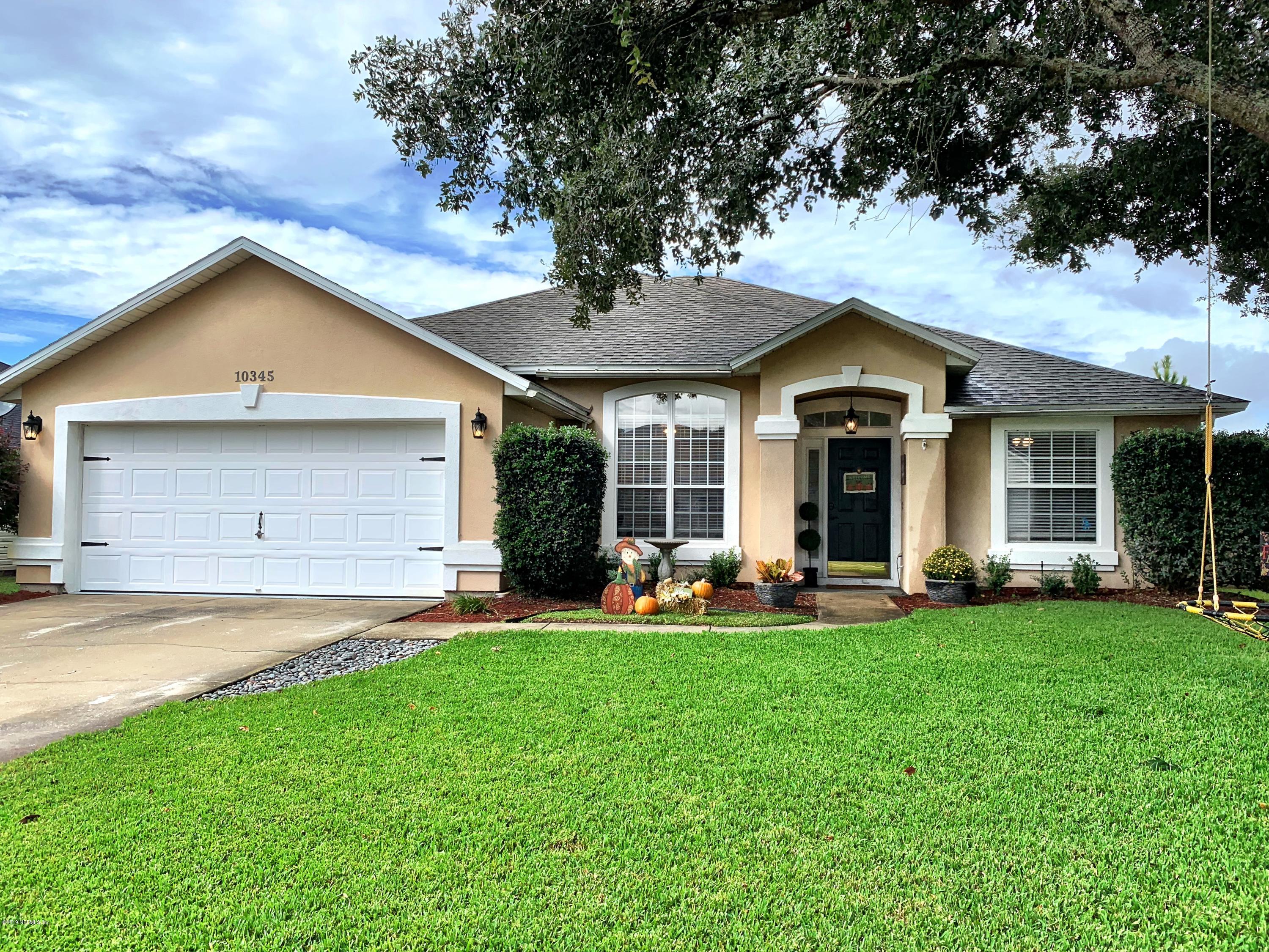 10345 Sugar Grove Road Jacksonville, FL 32221 - Photo 1 of 36 a front view of a house with a yard and porch