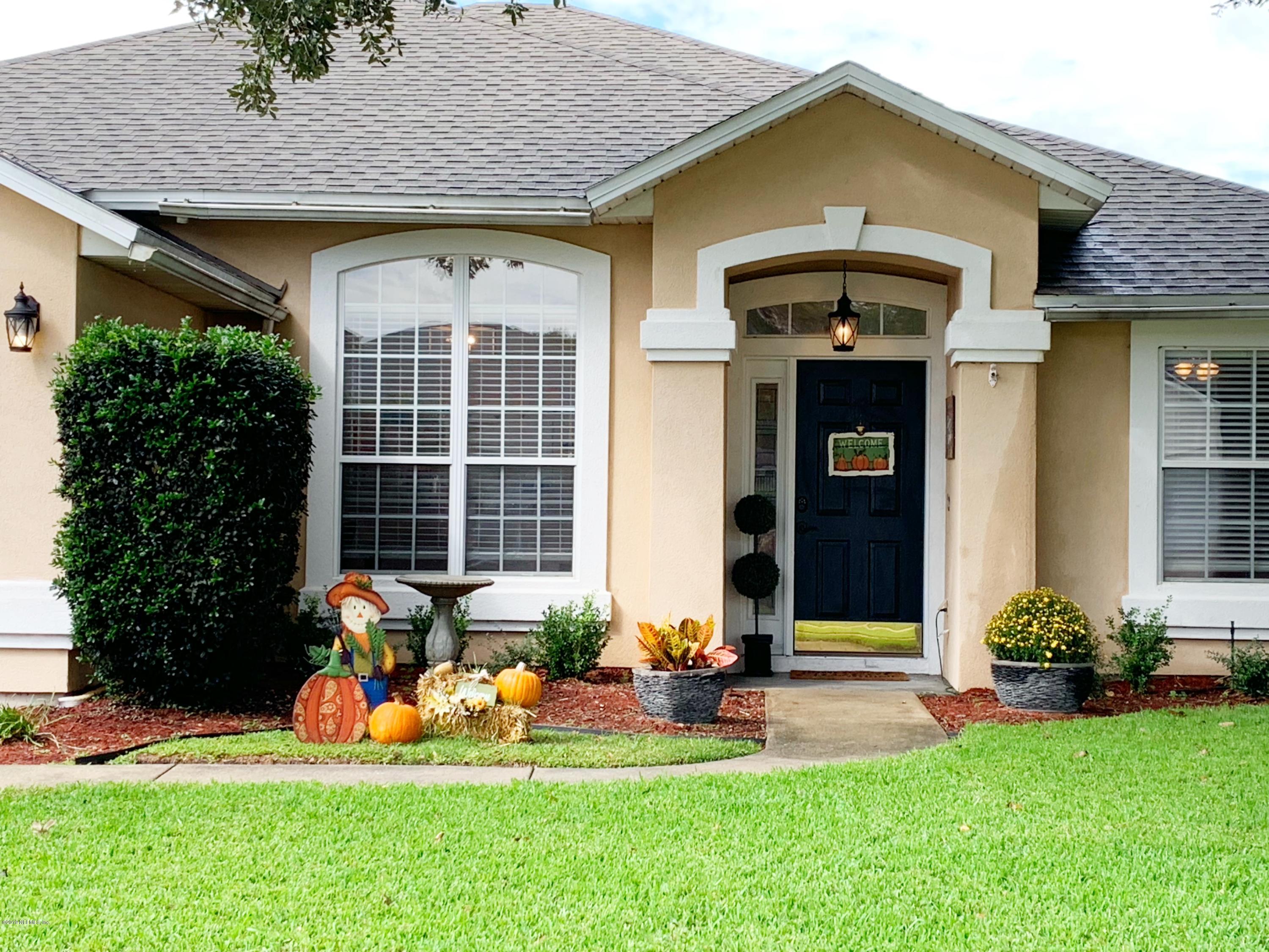 10345 Sugar Grove Road Jacksonville, FL 32221 - Photo 2 of 36 a front view of a house with a yard and potted plants