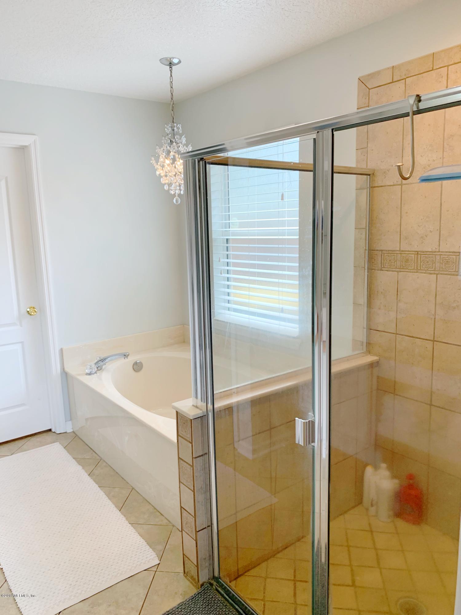 10345 Sugar Grove Road Jacksonville, FL 32221 - Photo 25 of 36 a bathroom with a bathtub and a shower
