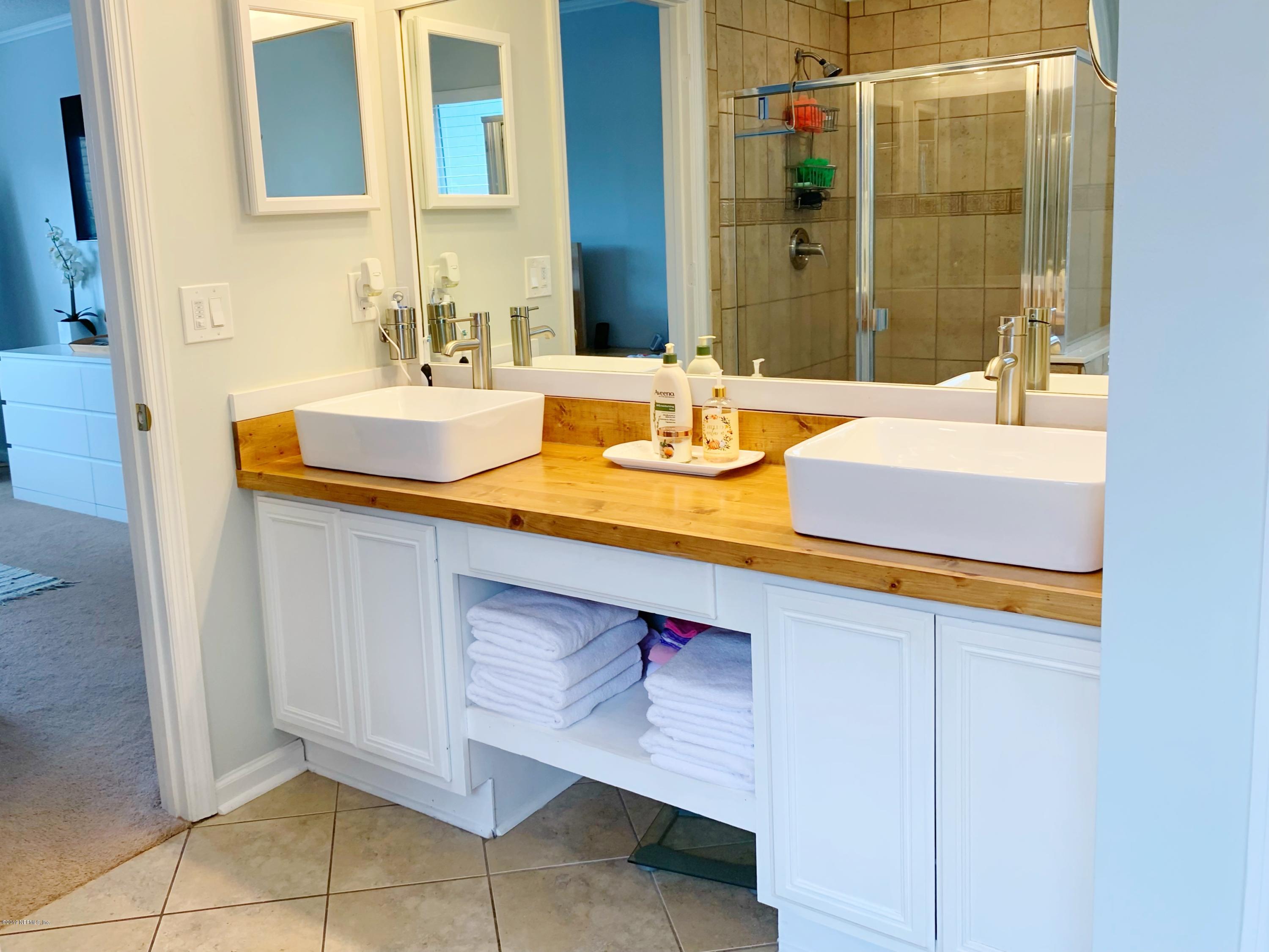 10345 Sugar Grove Road Jacksonville, FL 32221 - Photo 27 of 36 a bathroom with a sink and a mirror