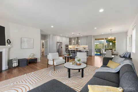 a living room with furniture kitchen view and a table