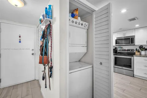 a hallway with a washer and dryer
