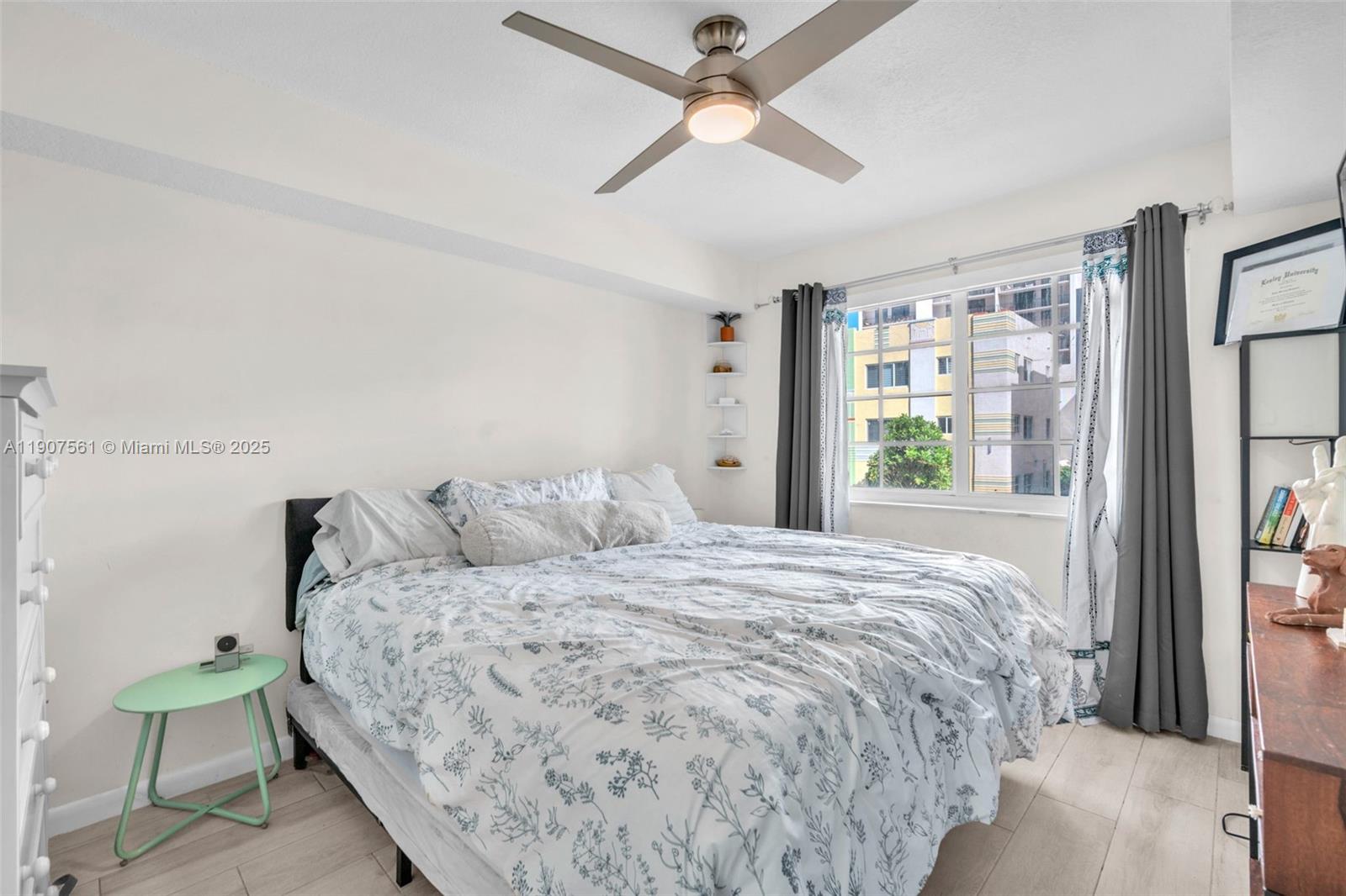 2600 Collins Avenue, Unit 206 Miami Beach, FL 33140 - Photo 15 of 25 a bedroom with a bed chandelier and a window