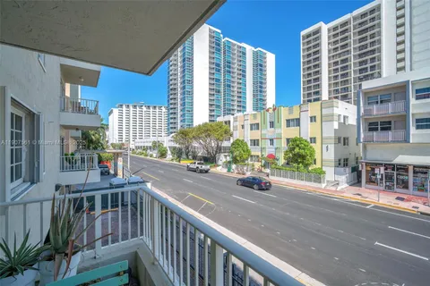 a view of a street with tall buildings
