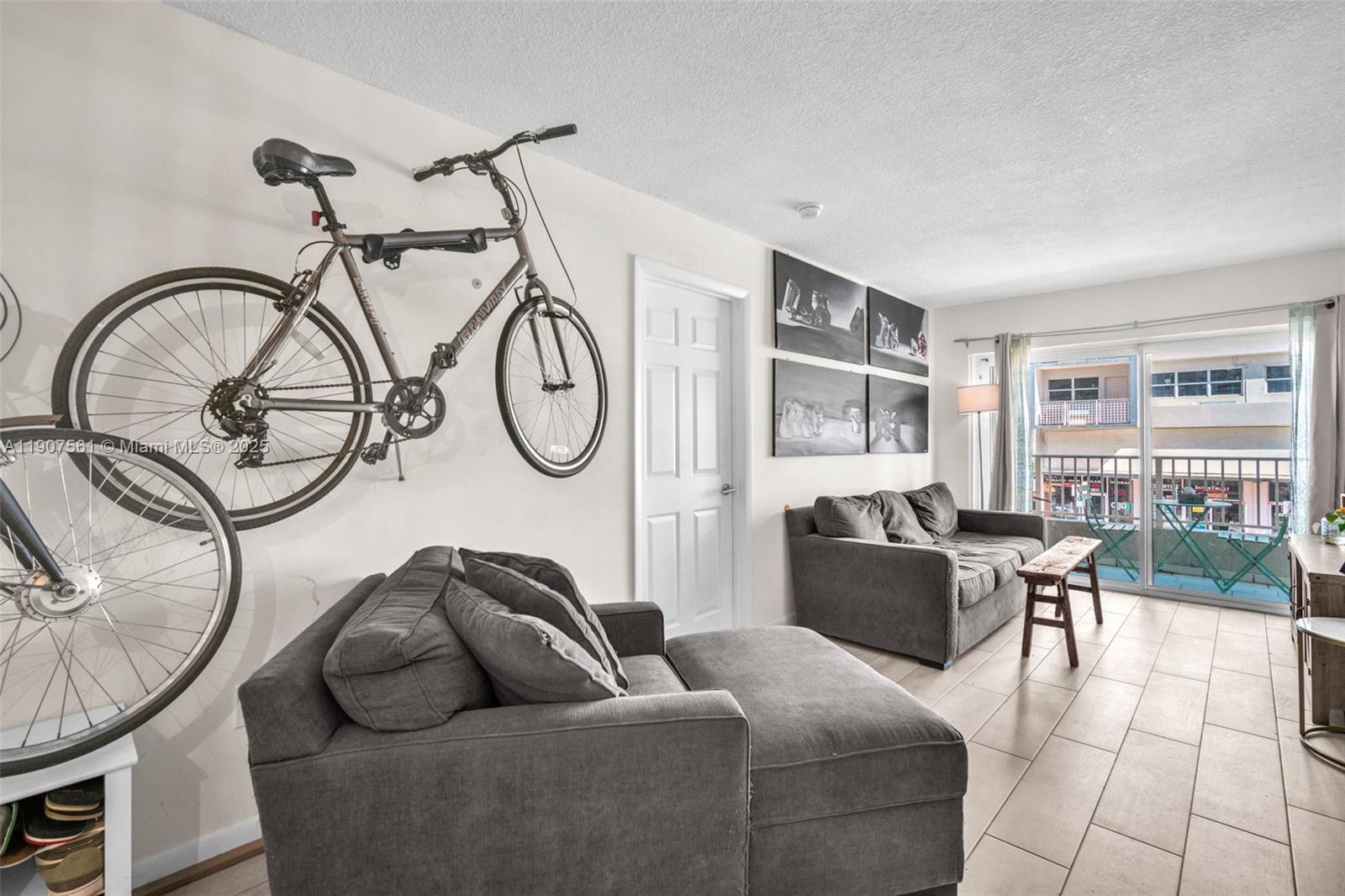 2600 Collins Avenue, Unit 206 Miami Beach, FL 33140 - Photo 8 of 25 a living room with furniture a couch and two windows