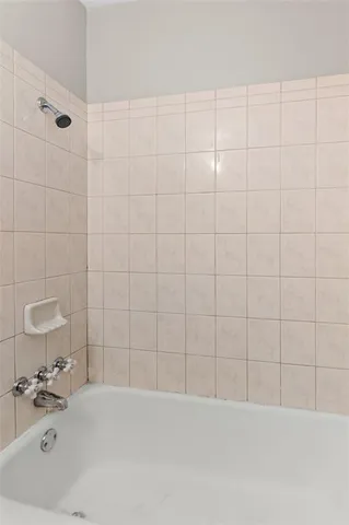 a bathroom with a bathtub and shower